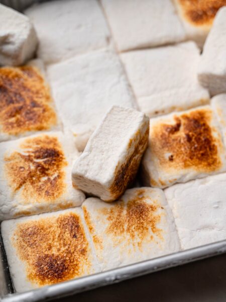 Toasted vegan marshmallows in a pan with golden brown tops.