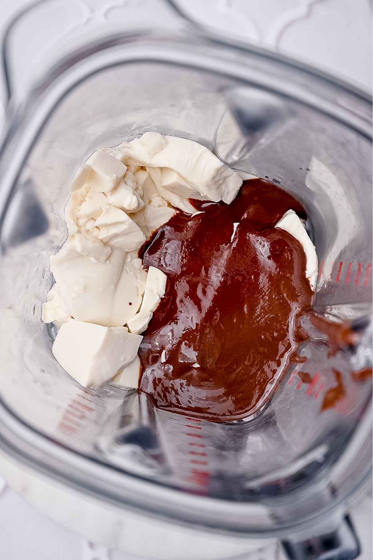 Silken tofu and melted dark chocolate added to a blender for chocolate tofu mousse.