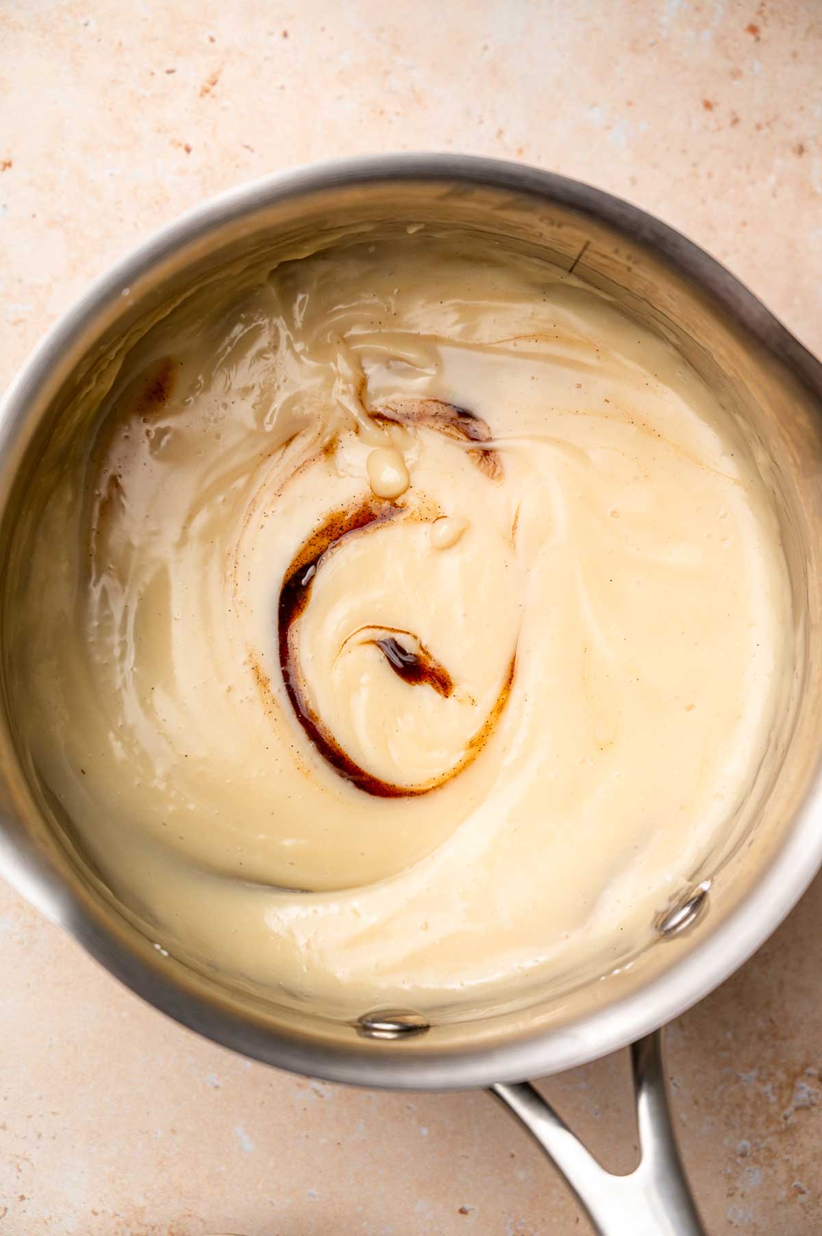 the thickened dairy free and eggless custard removed from heat with vanilla paste.