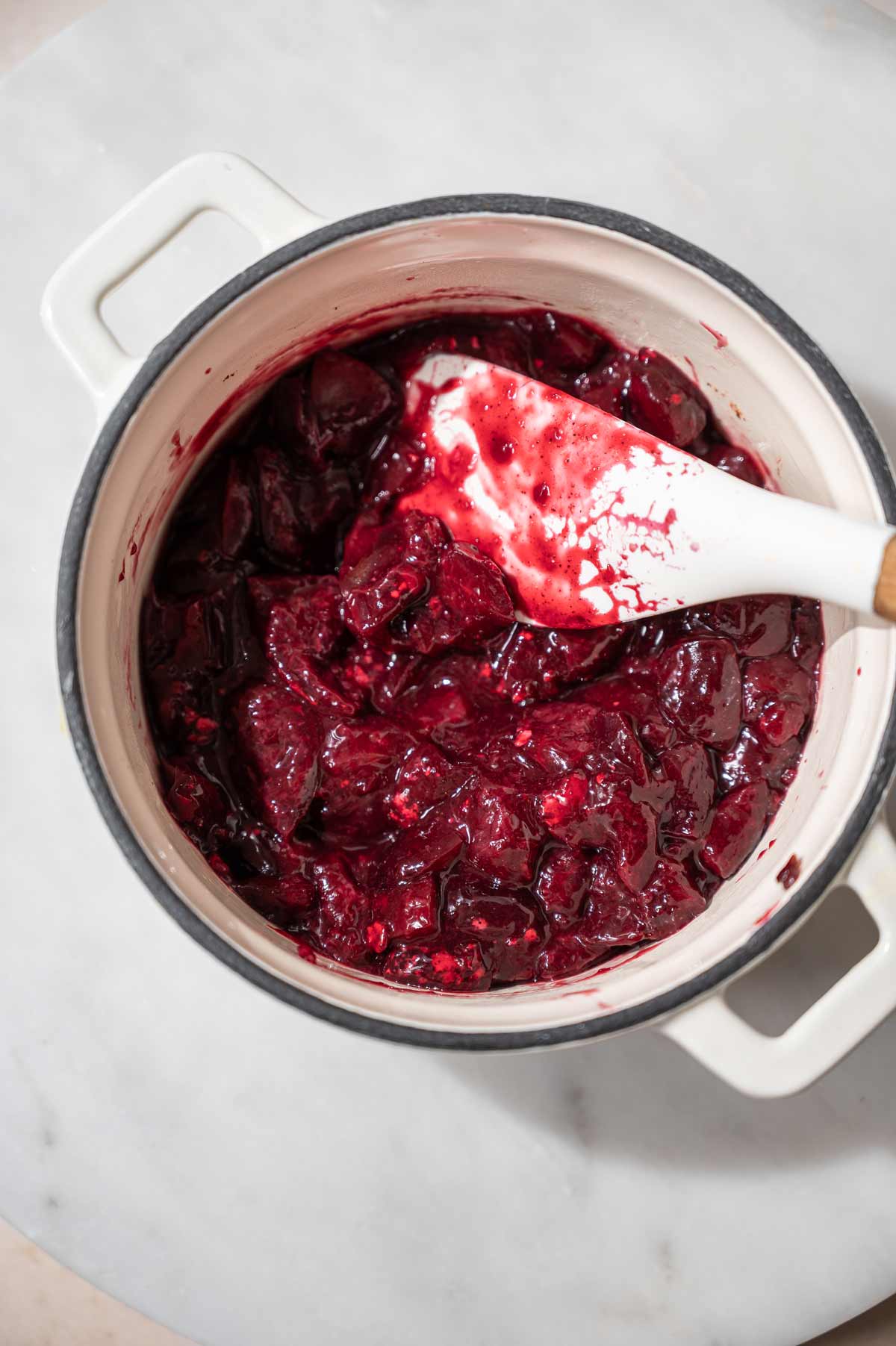 simmered fresh cherries with cinnamon in a saucepan.
