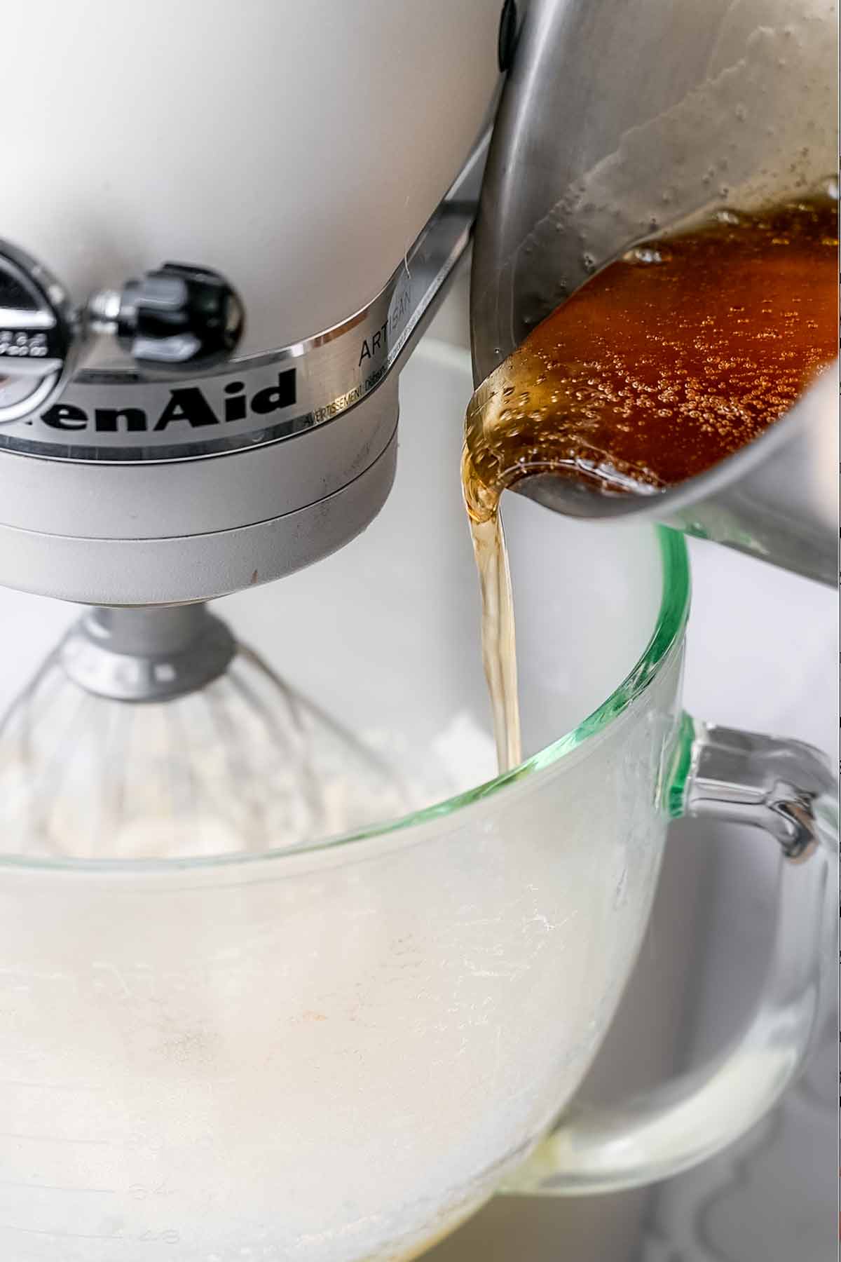 sugar syrup being slowly poured into the vegan marshmallow base.
