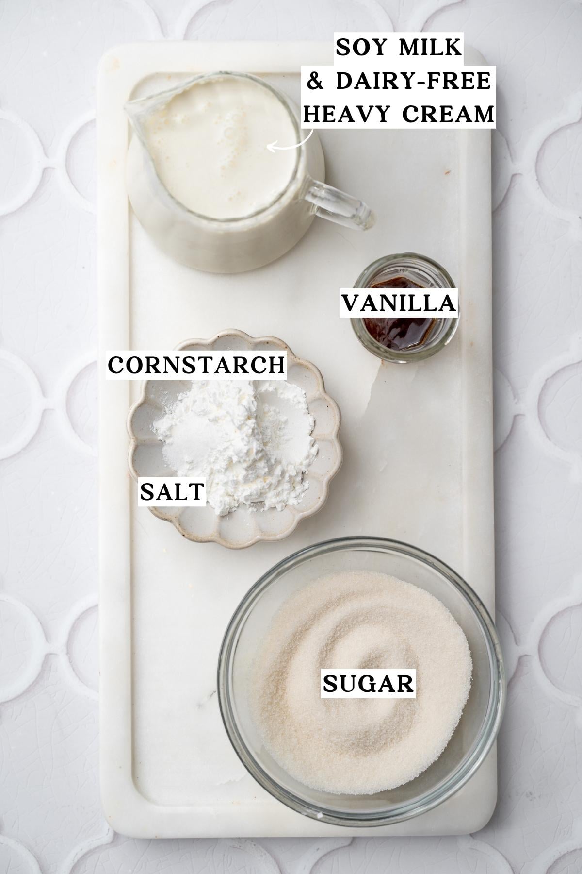 ingredients like soy milk, sugar and cornstarch on a marble tray.