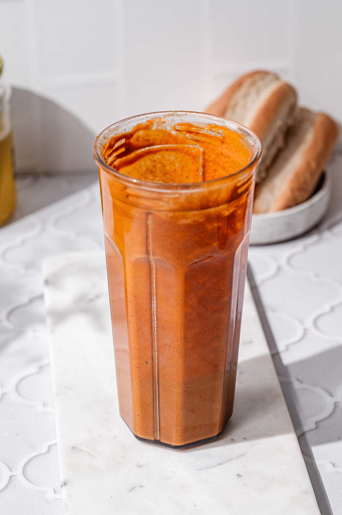 Smooth orange-red mixture blended until creamy and ready to mix into the dry ingredients.