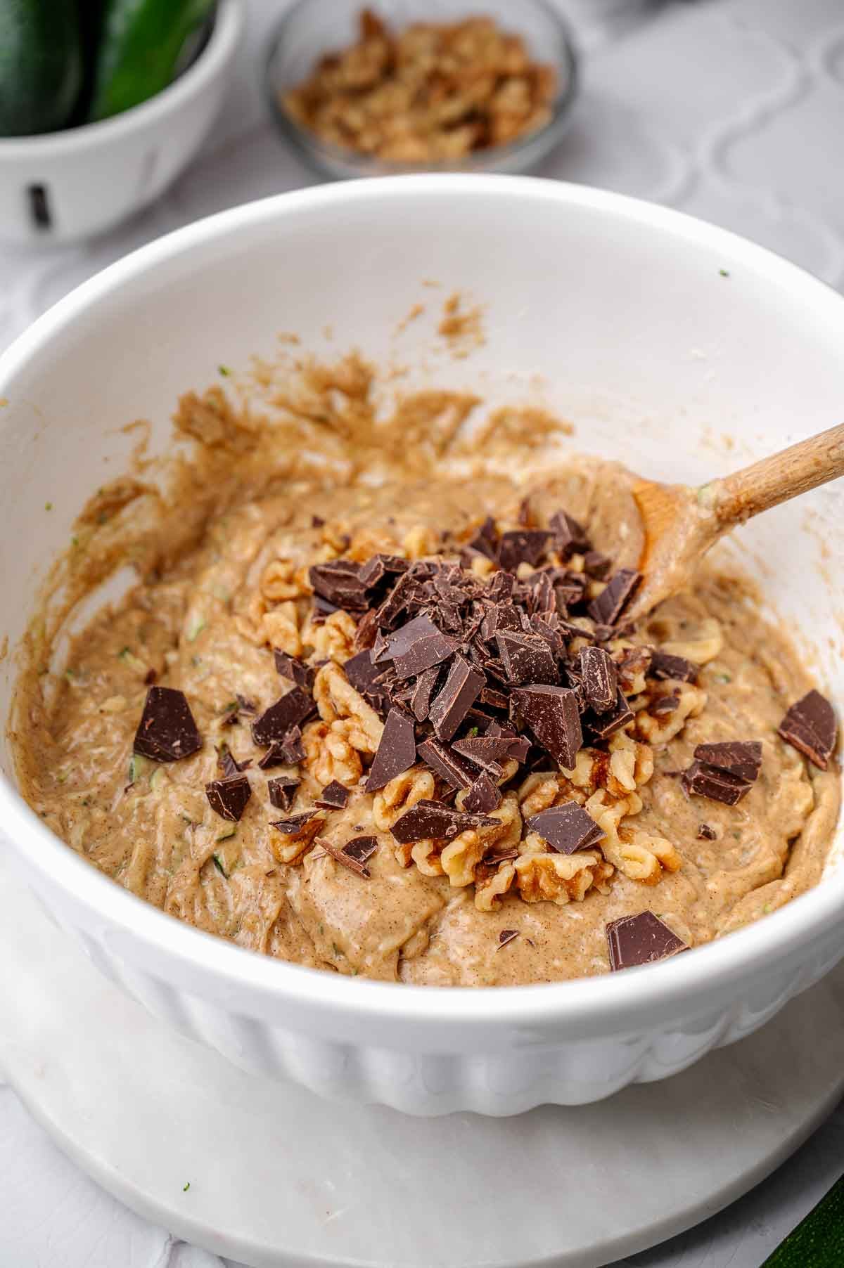 Thick zucchini bread batter with walnuts and chocolate chunks.