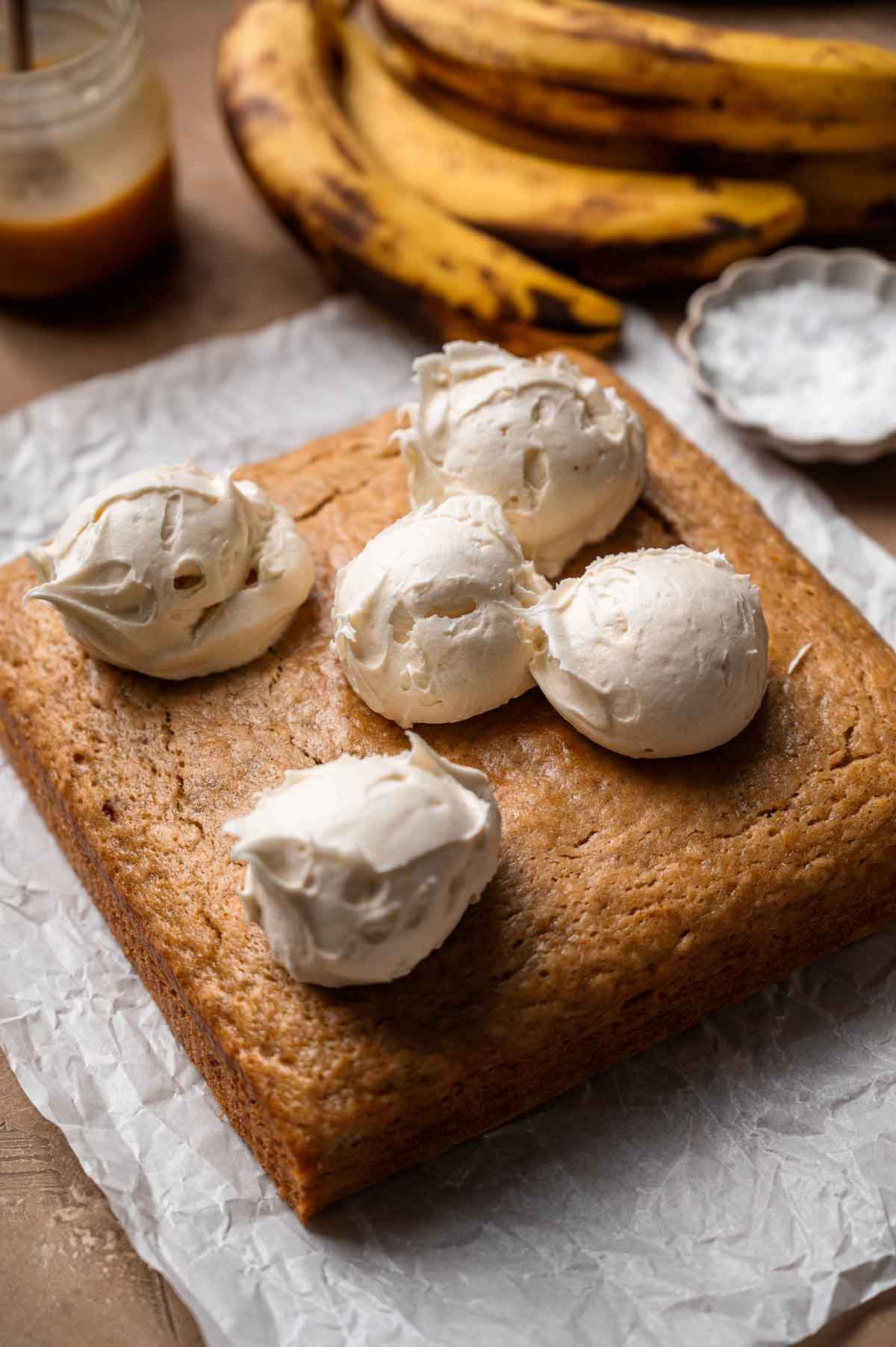 dairy free cream cheese frosting scooped on the baked cake.