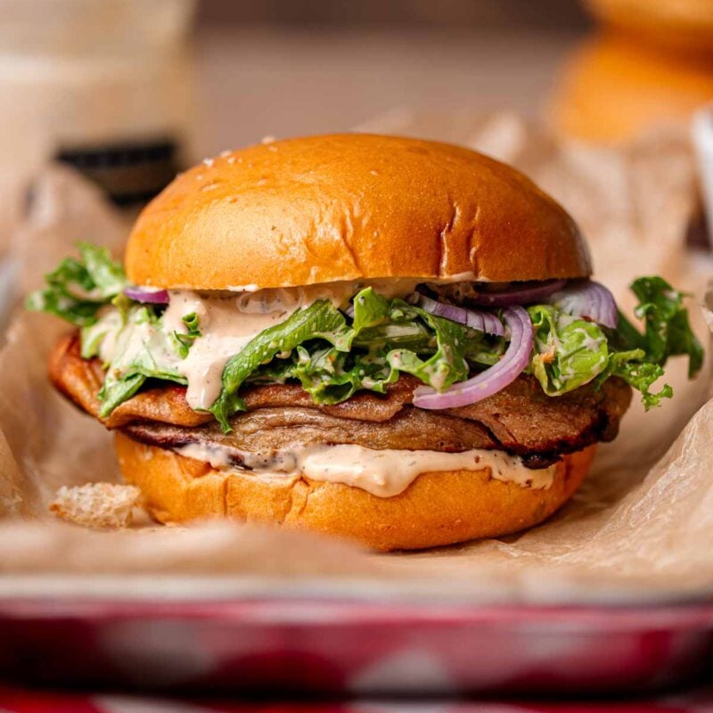 a vegan caesar sandwich with baked plant-based chicken.