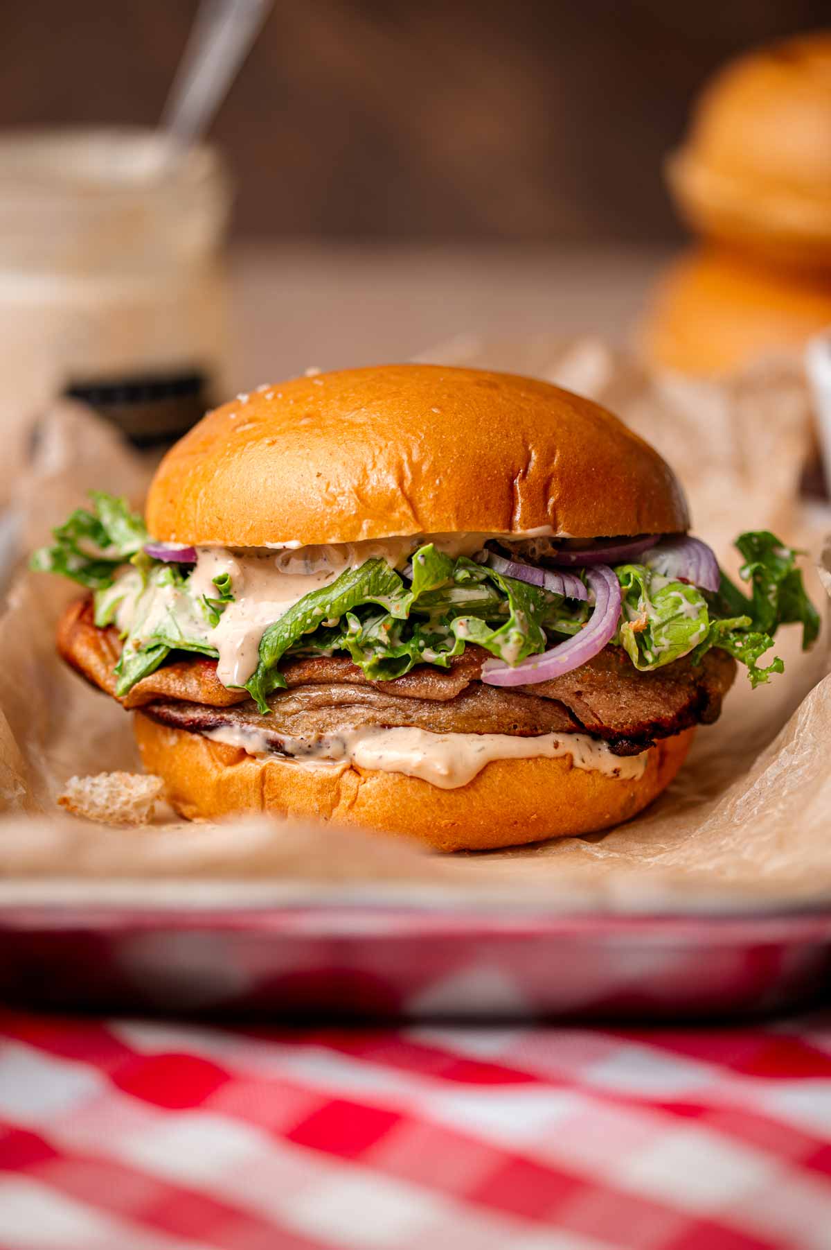 a vegan caesar sandwich with baked plant-based chicken.