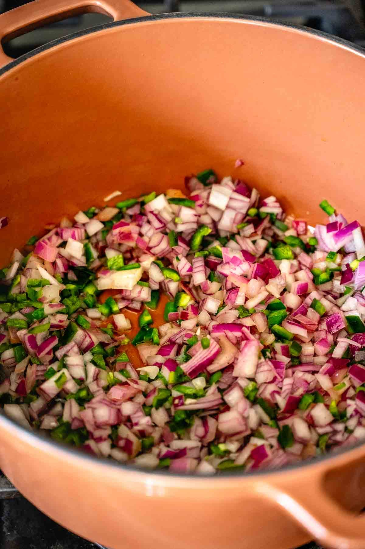 onions and peppers sweating in the heated Dutch oven.