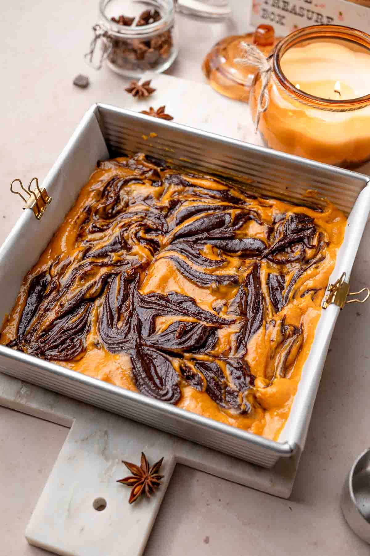 the vegan pumpkin brownie batter in a metal pan ready to bake.