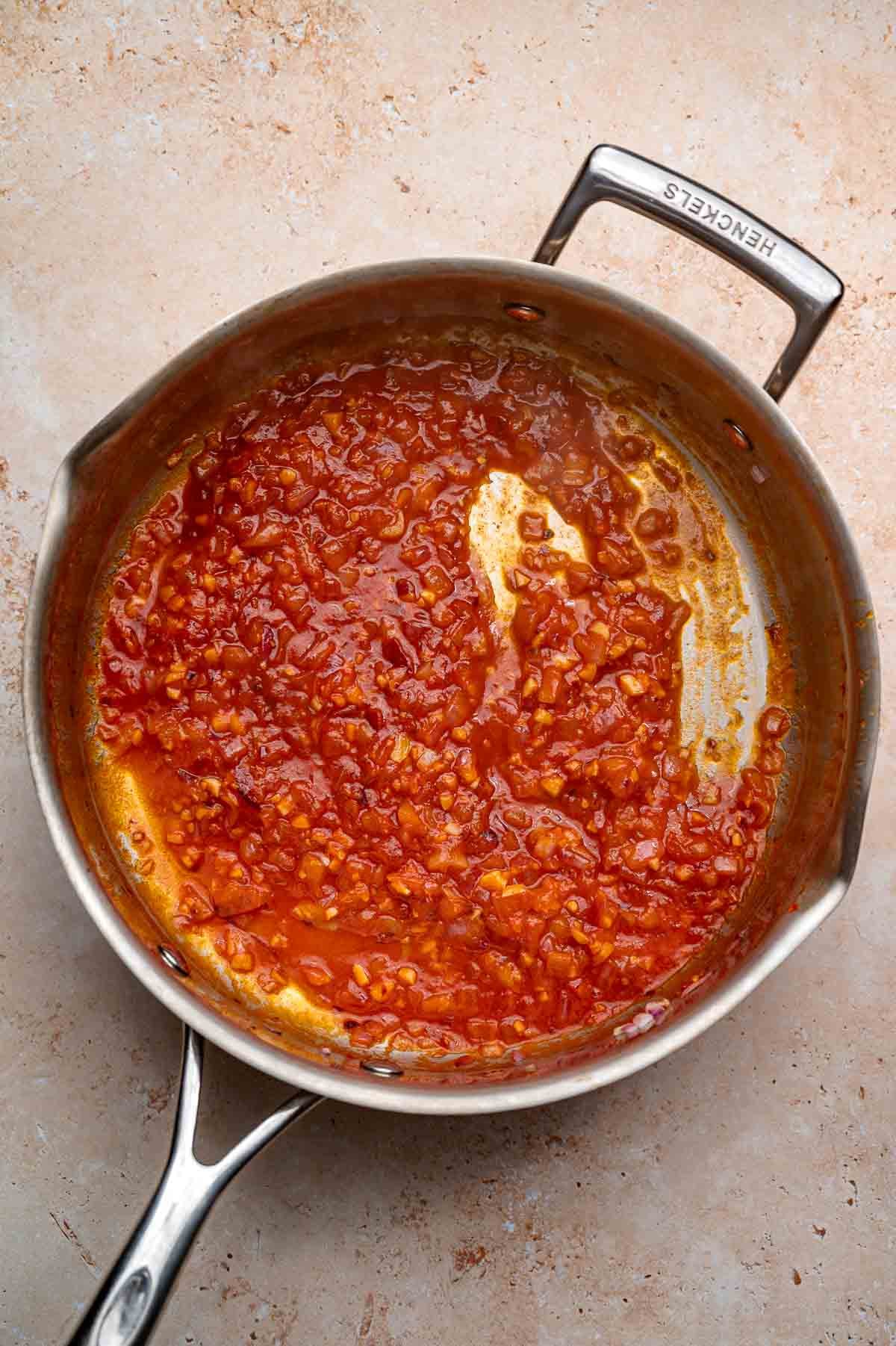 the tomato paste sauce in a stainless steel pan.